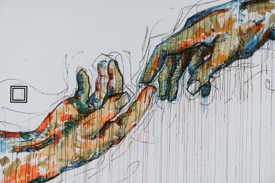 "colorful graphic of hands reaching out"